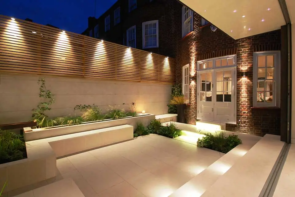 Garden lighting in a Manchester garden at night, warm-white fittings lighting a path and planting