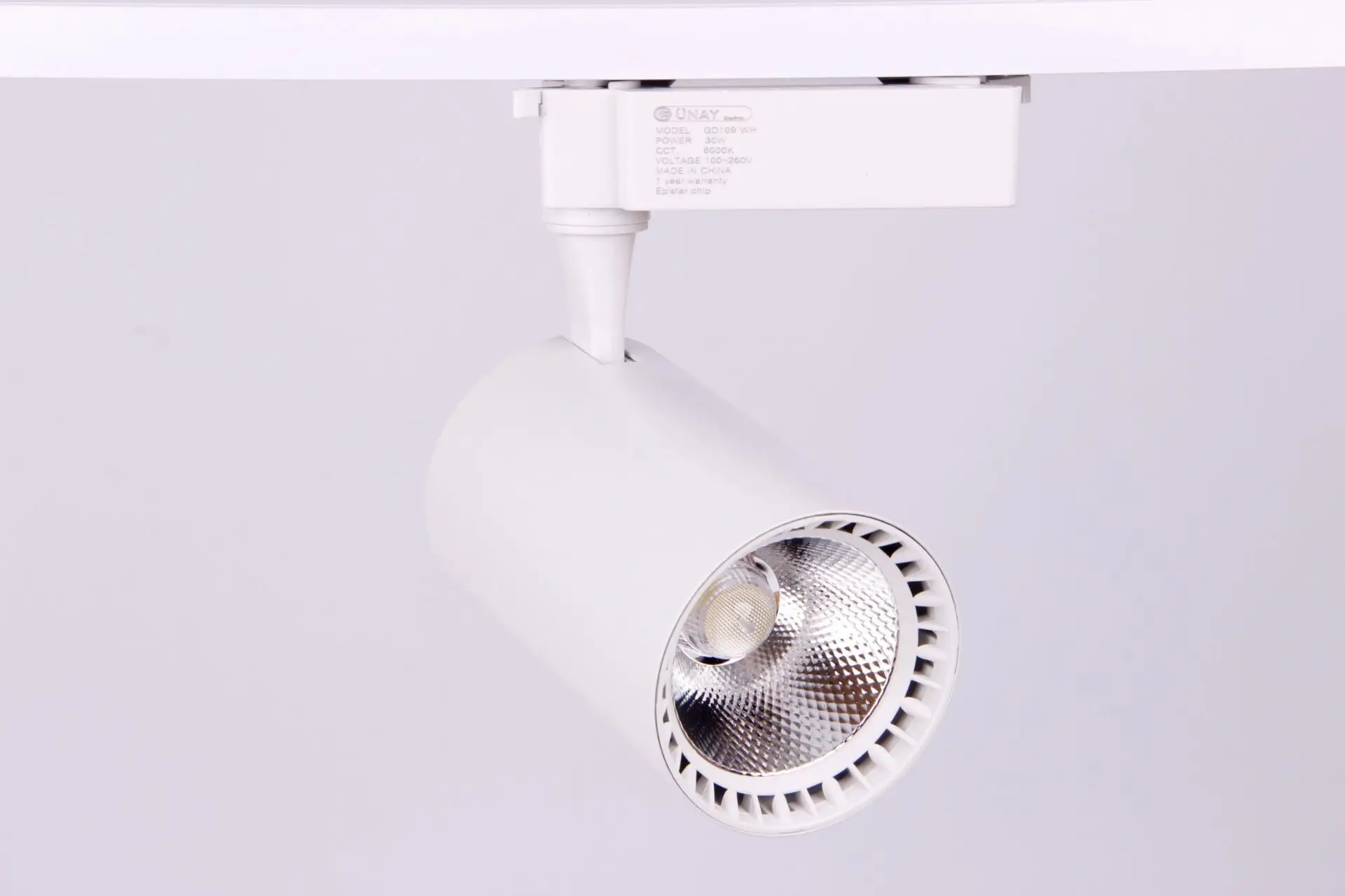 White LED track lighting mounted on a ceiling with adjustable spot heads