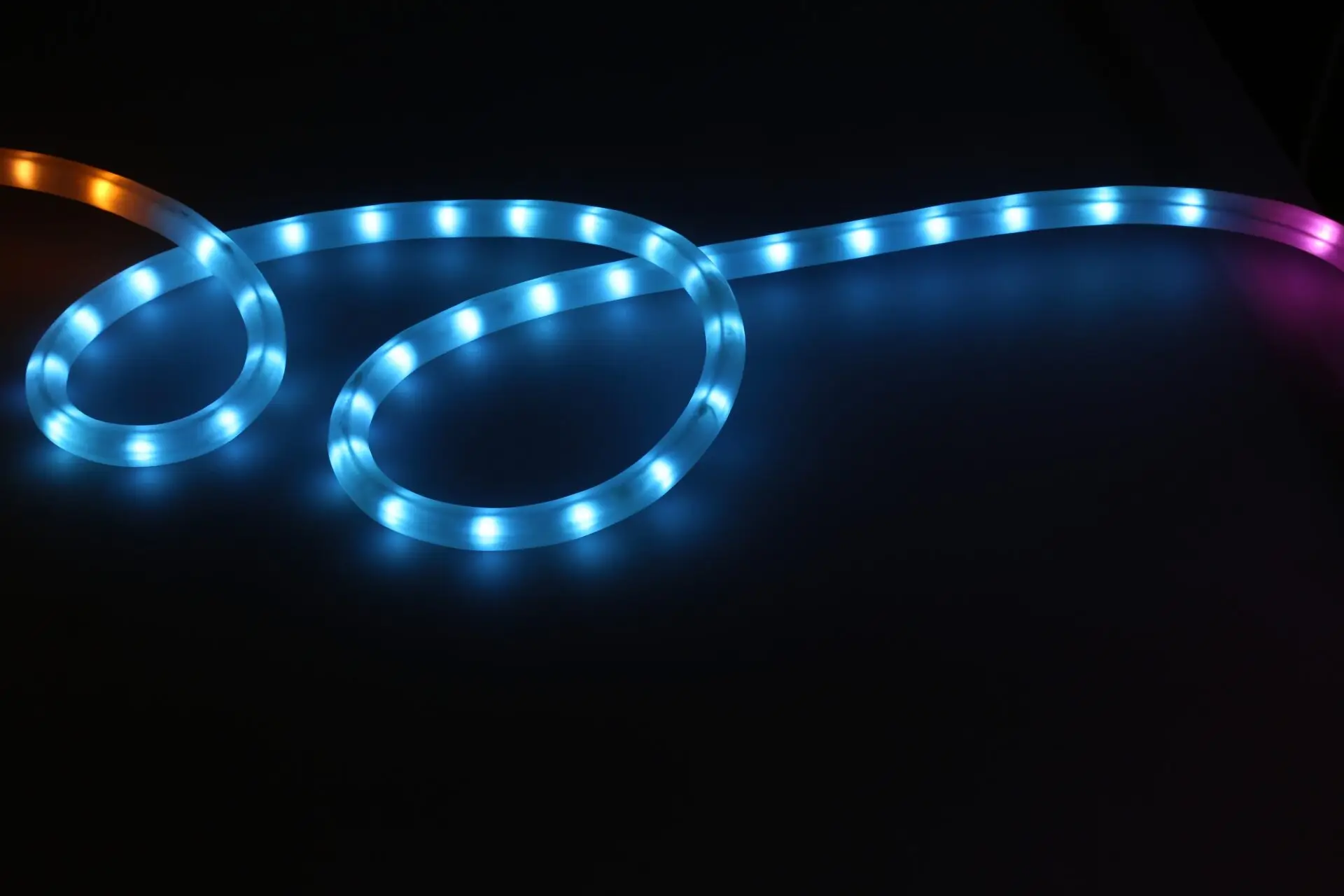 LED strip lights coiled and glowing against a dark background
