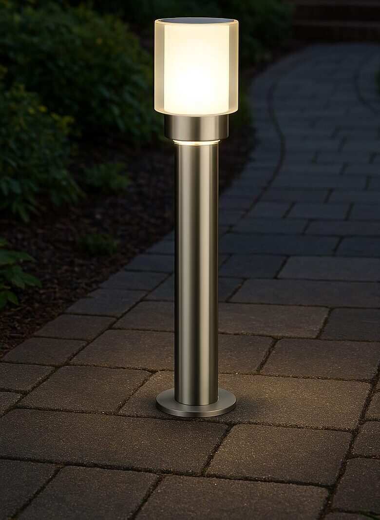 Warm-white paving lights used as garden lighting along a patio edge at dusk
